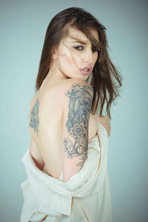 Beautiful elegant woman with tattoo on armの写真素材