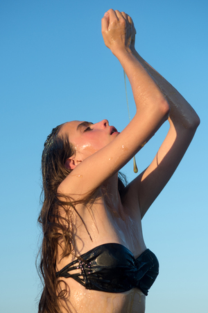 Honey dessert or nectar on woman face. honey facial mask on young woman in summerの写真素材