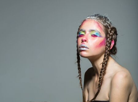 Beautiful girl with naked body, beauty. Woman with soft skin and makeup has fashionable hairstyle on...
