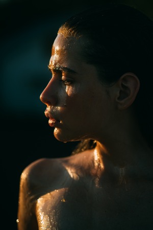 cosmetology and healthy skin of girl. cosmetology, young woman with honey on face and bodyの写真素材