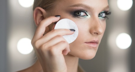 Skincare, treatment and therapy. Woman remove makeup with cotton pad. Beauty model with fresh face skin, skincare. Makeup application or removal. Woman use cotton pad for cleaning face skin.の写真素材