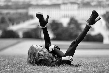 Stylish young girl on grassの写真素材