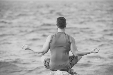 yogi having meditation at beach.の写真素材
