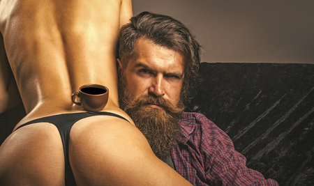 Hipster hold coffee cup on sexy female ass, eroticaの写真素材