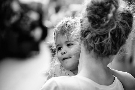 mother holds son in street