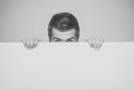 Hipster hide face behind white paper.の写真素材