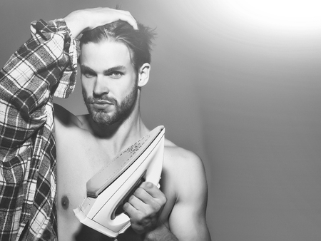 Sexy shirtless man with ironの写真素材