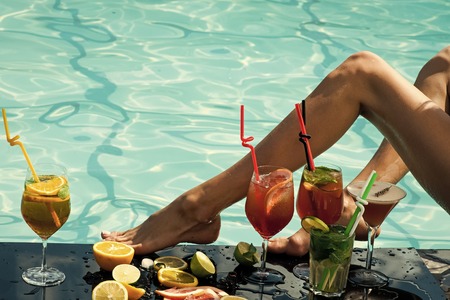 Woman with alcoholic beverage and fruit.