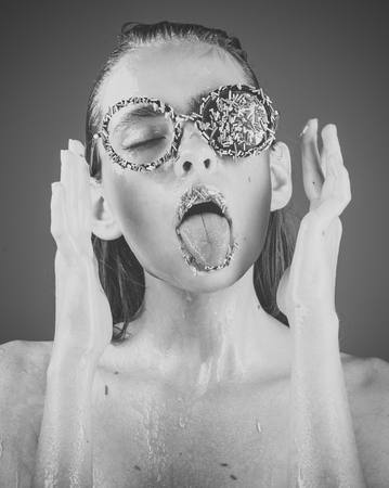 Makeup of sugar candy kiss on lips. Beauty and fashion model of glamour girl. Sprinkles lipstick and glasses on girl, valentines day. Young woman with sprinkles makeup. Diet and sweet dessert, easterの写真素材