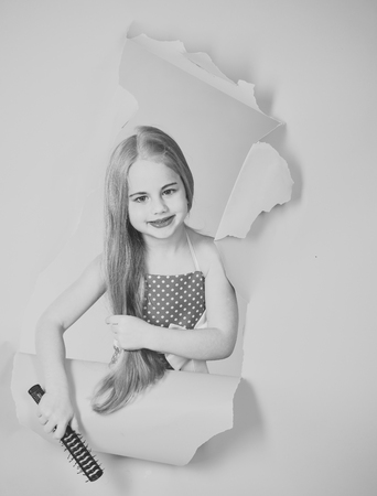 Little girl in vintage dress, prom. little girl with long hair hold brush.の写真素材