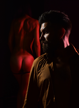 Undressed woman standing near bearded handsome manの写真素材