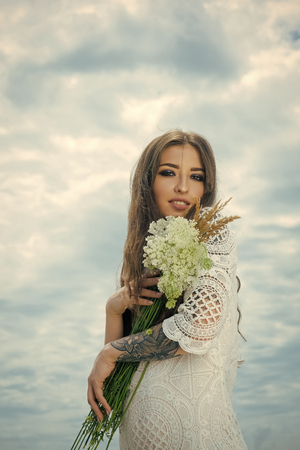 Woman with floral bouquet, fashionの写真素材