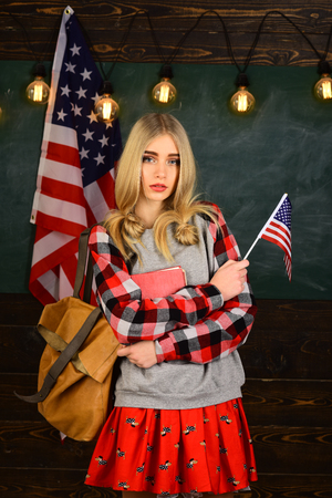 Student will have to be dedicated and self-disciplined to reach his goals. US flag and blackboard. Students works honestly. Successful tutors have specific content expertise.の写真素材