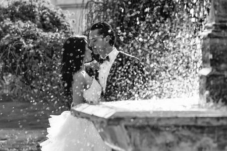 wedding couple kiss near fountain waterの写真素材