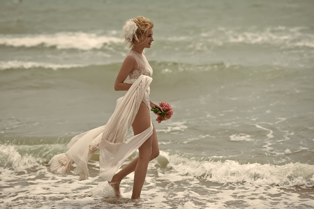 Sensual beautiful bride on beachの写真素材