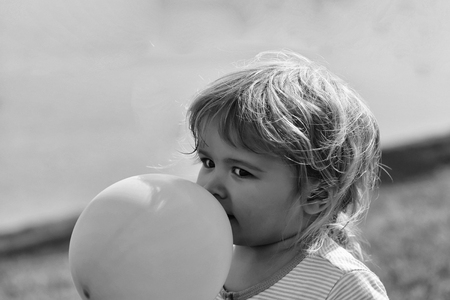 Baby boy plays with balloonの写真素材