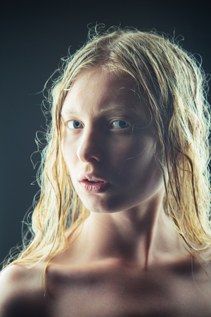 Girl looks like albino she has white skin and blond hair.の写真素材