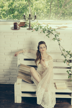 Fashion woman model read book. fashion girl relax on bench with bookの写真素材