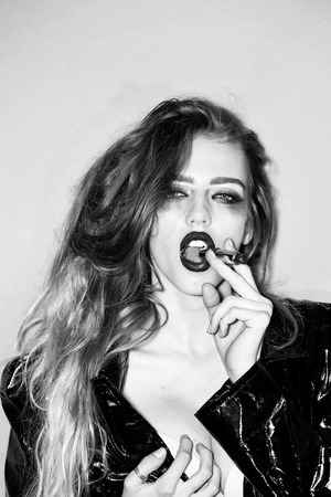 Pretty woman with lipstick in mouthの写真素材