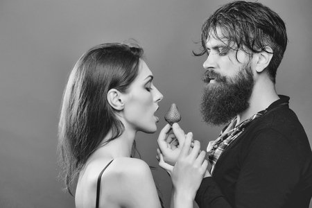 sexy couple eating red strawberryの写真素材