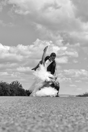 wedding happy couple dancing on roadの写真素材