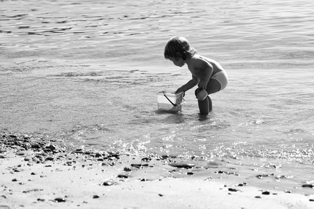 Happy kid having fun. Boy playing on beachの写真素材