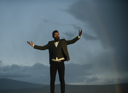 Bearded man smoke on natural landscape. Fashion smoker on fresh air. Hipster with cigarette and...