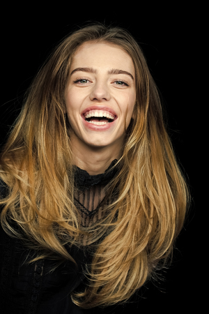 Woman with stylish long hair and no makeup.