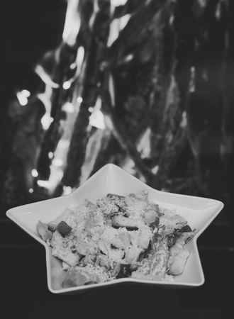 Caesar salad served in white plate in shape of star. Traditional dish in the restaurant - Caesar...
