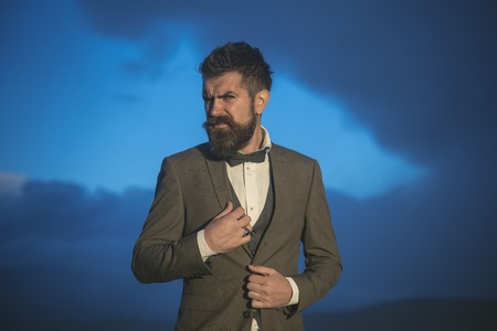 Brutal bearded male looks down over cloudy sky.の写真素材