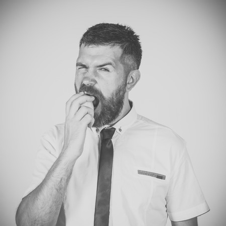 Face fashion boy or Man in your web site. Man face portrait in your advertisnent. Man with long beard eat lemon.の写真素材