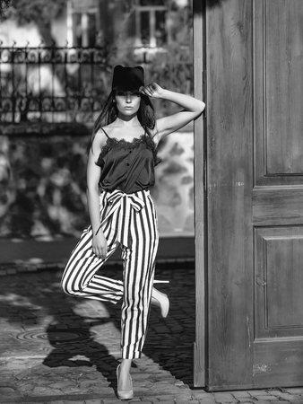 Face fashion girl or Women in your web site. Girl face portrait in your advertisnent. Woman near wooden doorの写真素材