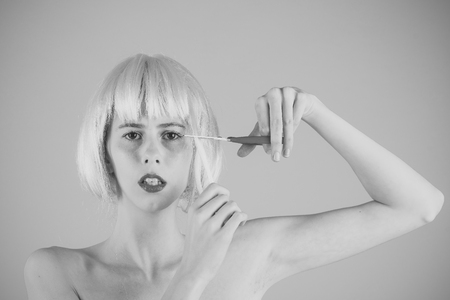 Female Face. Issues affecting girls. Woman in wig on pink background.の写真素材