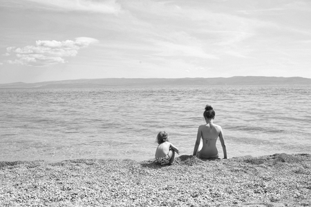 Kids playing with toys. mother and son on beachの写真素材