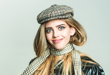 Makeup look for woman with soft skin. Autumn fashion for woman in hat and scarf. Trendy girl with makeup on sensual face. Beauty and hairdresser. Sexy woman with stylish long hair in leather coat.の写真素材