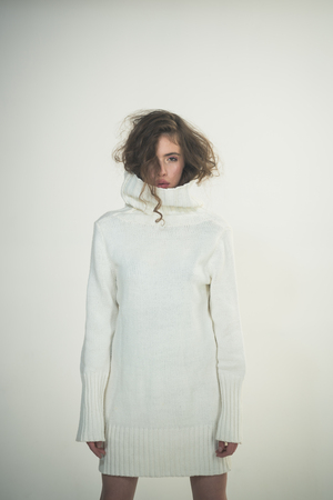 Trendy woman with stylish hair in white winter sweater. Fashion look concept. Girl with makeup on pretty face. Beauty and hairdresser. Makeup for model with soft skin. Perfect femaleの写真素材