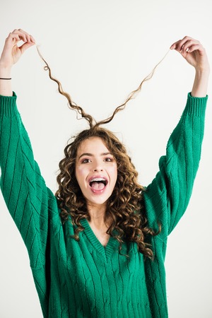 girl with long and shiny wavy hair. Beautiful model woman with curly hairstyle.の写真素材