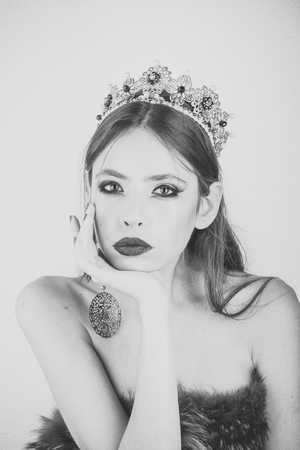 Beauty fashion portrait. Makeup for woman with soft skin, elegance. Cosmetics for makeup and skincare, hairdresser. Fashion girl with elegant look. Beauty queen and fashion. Luxury of woman in crown and earrings jewelryの写真素材
