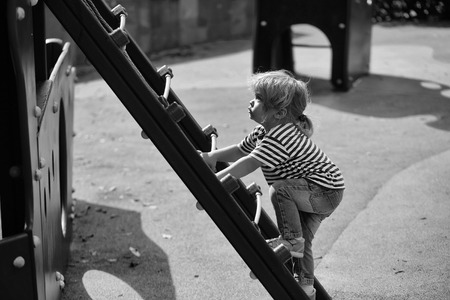 childrens playgrounds for children. Cute baby boy climbs ladderの写真素材