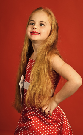 young model. Retro look, hairdresser, makeup. Retro girl or fashion model, beauty. Child girl in stylish glamour elegant dress. Little girl in vintage dress, prom. Fashion and beauty, pinup style, childhoodの写真素材