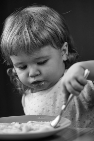 baby eats porridge. Little boy eatingの写真素材