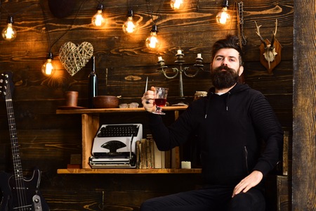 Relaxing evening. Guy in cozy warm atmosphere drinking. Man bearded enjoy evening with warming...