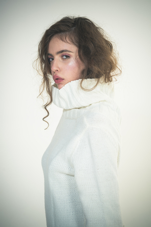 Girl with makeup on pretty face. Beauty and hairdresser. Trendy woman with stylish hair in white winter sweater. Makeup for model with soft skin. Fashion look concept. Looking trendy.の写真素材