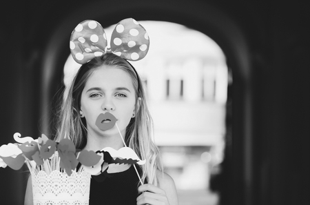 Beauty fashion portrait. Funny pretty girl with cute mouse ears and red lipsの写真素材