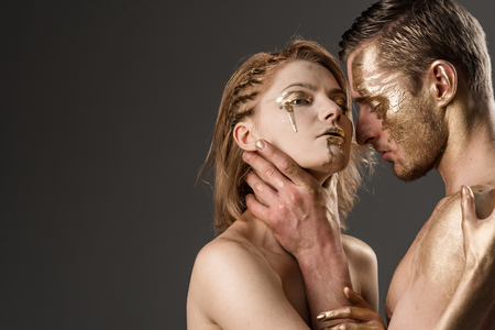 success concept. success and luxury concept with sexy couple painted in gold color, copy space.の写真素材