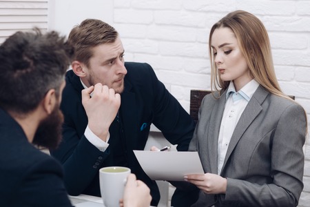 Business negotiations, discuss conditions of deal. Man with beard drinks tea while waiting for bosses decision. Negotiations concept. Business partners or businessman at meeting, office backgroundの写真素材