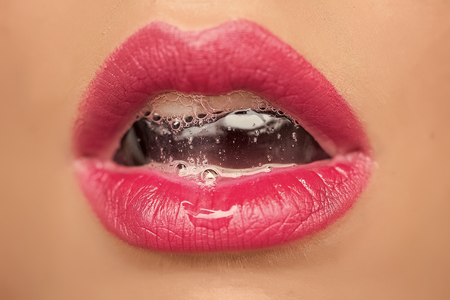 Female lips close-up. Female mouth with bubbleの写真素材