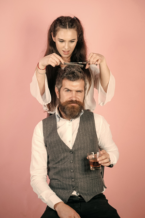 Beauty Fashion model girl. Fashion look. Woman with razor, comb cut hair of man.の写真素材