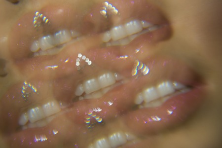 Shine on. Duplication of lips defocused and blurred. White teeth and dental care. Lips makeup and cosmetics. Beauty and fashion art. Sexy lipsの写真素材