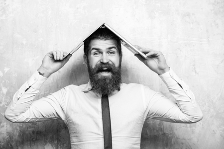 office worker. happy bearded man with long beard hold laptopの写真素材